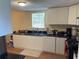 Bright kitchen features white cabinets, dark countertops, and modern appliances, perfect for cooking enthusiasts at 1421 Isleworth Cir, College Park, GA 30349