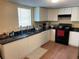 Functional kitchen area with white cabinets, black countertop, offering ample space and practicality at 1421 Isleworth Cir, College Park, GA 30349