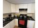 Functional kitchen with white cabinets, black countertop, and essential appliances for everyday cooking at 1421 Isleworth Cir, College Park, GA 30349