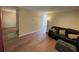 Open-concept living area with wood floors, sofa seating, and access to other rooms, ideal for gatherings at 1421 Isleworth Cir, College Park, GA 30349