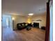 Spacious living room featuring hardwood flooring, a decorative fireplace, and comfortable seating at 1421 Isleworth Cir, College Park, GA 30349
