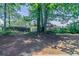 A view of the property's spacious backyard with mature trees and a wooded lot at 1363 To Lani Farm Rd, Stone Mountain, GA 30083