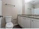 Well-lit bathroom featuring a granite countertop vanity, white cabinetry, and modern fixtures at 1363 To Lani Farm Rd, Stone Mountain, GA 30083