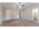 Bright bedroom featuring a ceiling fan, plush carpet, and access to an ensuite bathroom at 1363 To Lani Farm Rd, Stone Mountain, GA 30083