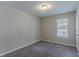 Cozy bedroom with neutral carpet, a window with blinds, and a ceiling light, perfect for comfort and relaxation at 1363 To Lani Farm Rd, Stone Mountain, GA 30083