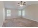 Spacious bedroom with neutral carpet, a ceiling fan, and large windows that provide plenty of natural light at 1363 To Lani Farm Rd, Stone Mountain, GA 30083