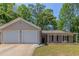 Charming single-story home with a two-car garage, well-maintained lawn and beautiful landscaping with plenty of mature trees at 1363 To Lani Farm Rd, Stone Mountain, GA 30083