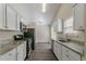 Modern kitchen with white cabinets, granite countertops, and stainless steel appliances at 1363 To Lani Farm Rd, Stone Mountain, GA 30083