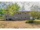 Backyard view of the home with brick and painted siding, mature trees, and lawn at 2032 Parker Ranch Se Rd, Atlanta, GA 30316