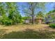Spacious backyard with green grass, trees, and a shed, offering plenty of room at 2032 Parker Ranch Se Rd, Atlanta, GA 30316