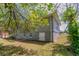 Side view of the backyard with the house featuring updated siding and a door to the basement at 2032 Parker Ranch Se Rd, Atlanta, GA 30316