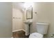 Bathroom with pedestal sink, modern fixtures, toilet and new vinyl plank flooring at 2032 Parker Ranch Se Rd, Atlanta, GA 30316