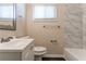Bathroom featuring a vanity with white cabinetry and a marble-tiled shower and bathtub at 2032 Parker Ranch Se Rd, Atlanta, GA 30316