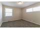 Bright bedroom with two windows, neutral walls, plush carpeting, and baseboard heating at 2032 Parker Ranch Se Rd, Atlanta, GA 30316