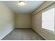 Bright bedroom features neutral walls, plush carpeting, and ample natural light from a window at 2032 Parker Ranch Se Rd, Atlanta, GA 30316