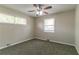 Cozy bedroom with two large windows, neutral walls, plush carpeting, and a ceiling fan at 2032 Parker Ranch Se Rd, Atlanta, GA 30316