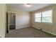 Bedroom with natural light, neutral walls, plush carpet, and white painted wood paneling at 2032 Parker Ranch Se Rd, Atlanta, GA 30316