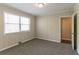 Bedroom with natural light, neutral walls, plush carpet, and white painted wood paneling at 2032 Parker Ranch Se Rd, Atlanta, GA 30316