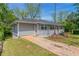 Charming single-story home boasts a gray exterior, new roof, a brick foundation, and a well-manicured front yard at 2032 Parker Ranch Se Rd, Atlanta, GA 30316