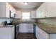 Modern kitchen features granite countertops, white cabinets, and stainless steel appliances at 2032 Parker Ranch Se Rd, Atlanta, GA 30316