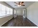 Bright living room with laminate floors, ceiling fan, fresh paint, and a large set of windows at 2032 Parker Ranch Se Rd, Atlanta, GA 30316