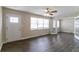 Bright living room with laminate floors, fresh paint, ceiling fan, and a large set of windows at 2032 Parker Ranch Se Rd, Atlanta, GA 30316