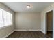 Room with laminate floors, a ceiling light, and one large window at 2032 Parker Ranch Se Rd, Atlanta, GA 30316