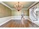 Formal dining room showcasing hardwood floors and staircase to the right at 320 Chason Wood Way, Roswell, GA 30076