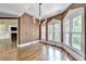 Dining room featuring hardwood floors, a chandelier, and large windows with natural light at 320 Chason Wood Way, Roswell, GA 30076