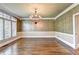 Formal dining room featuring wainscoting, hardwood floors, and a chandelier at 320 Chason Wood Way, Roswell, GA 30076