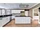Bright kitchen with hardwood floors, white cabinets, black countertops, and stainless steel appliances at 320 Chason Wood Way, Roswell, GA 30076
