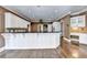 Spacious kitchen with hardwood floors, white cabinetry, and black countertops for a sleek design at 320 Chason Wood Way, Roswell, GA 30076