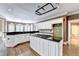 Spacious kitchen features a large island, stainless steel appliances, and hardwood floors at 320 Chason Wood Way, Roswell, GA 30076