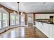Spacious kitchen and dining area with hardwood floors, white cabinetry, and views of the outdoor space at 320 Chason Wood Way, Roswell, GA 30076