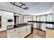 The kitchen has a large island, stainless appliances including microwave and wine cooler, with hardwood floors at 320 Chason Wood Way, Roswell, GA 30076