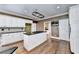 Modern kitchen featuring hardwood floors, a central island, white cabinetry, and black countertops at 320 Chason Wood Way, Roswell, GA 30076
