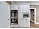 Custom kitchen cabinetry featuring stainless double ovens and microwave at 320 Chason Wood Way, Roswell, GA 30076