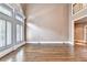 Bright living room with hardwood floors and tall windows with white shutters allowing ample natural light at 320 Chason Wood Way, Roswell, GA 30076
