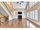Bright open living room with a fireplace, built-in shelves, large windows, and hardwood floors at 320 Chason Wood Way, Roswell, GA 30076
