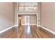 Open living room with hardwood floors, soaring ceiling, and a second-floor balcony overlooking the space at 320 Chason Wood Way, Roswell, GA 30076