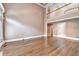 Open living room showcasing the hardwood floors and balcony with white trim and railing at 320 Chason Wood Way, Roswell, GA 30076