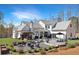 Expansive backyard featuring a large patio, outdoor seating, and mature landscaping at 1455 Rucker Cir, Woodstock, GA 30188