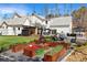 Expansive backyard featuring a garden, patio, outdoor dining, and volleyball court at 1455 Rucker Cir, Woodstock, GA 30188