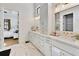 Bright bathroom with white cabinets, gold hardware, marble floors, and dual sinks at 1455 Rucker Cir, Woodstock, GA 30188