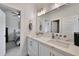 Elegant bathroom with double sinks, quartz countertop, and a well-lit vanity mirror at 1455 Rucker Cir, Woodstock, GA 30188