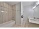 Bright bathroom features a double vanity, soaking tub and modern fixtures at 1455 Rucker Cir, Woodstock, GA 30188