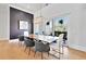 Dining room with a black accent wall, modern lighting, and view to outdoor at 1455 Rucker Cir, Woodstock, GA 30188
