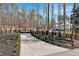 Long brick driveway leading to a black gated fence and beautiful white home at 1455 Rucker Cir, Woodstock, GA 30188