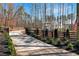 Long driveway leading to a beautiful home with manicured landscaping at 1455 Rucker Cir, Woodstock, GA 30188