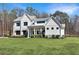 Beautifully landscaped two-story home featuring a covered front porch, manicured lawn, and charming curb appeal at 1455 Rucker Cir, Woodstock, GA 30188